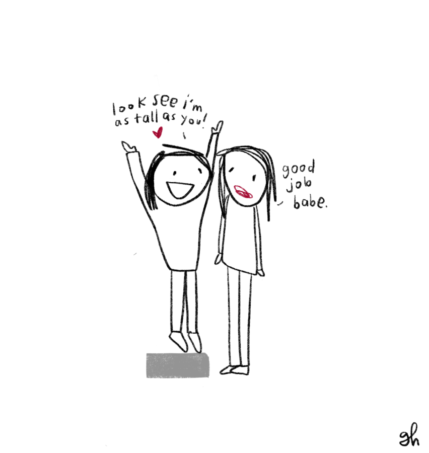 cartoon of Gretchen standing on a block saying "look see i'm as tall as you" and riese standing on the ground going "good job babe"
