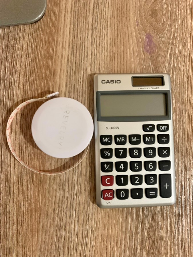 neurodiverse life hacks: a grey Casio calculator on a wooden desk