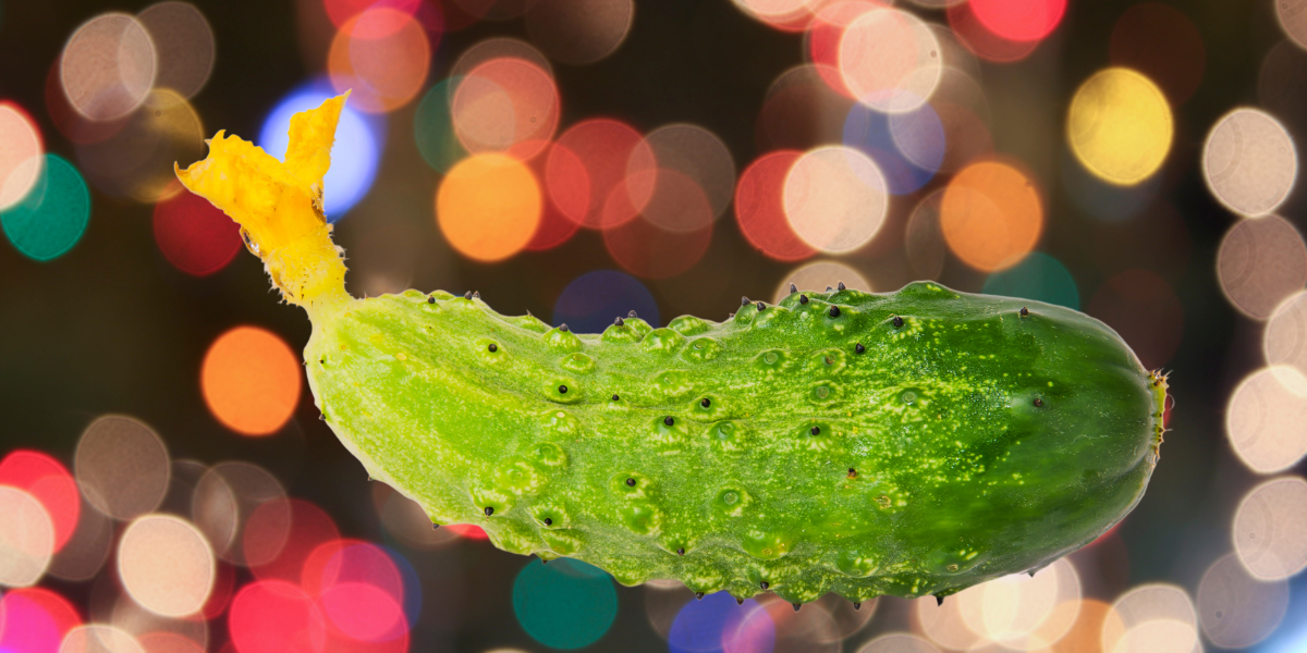 a cucumber with a flower on top set against a glittering background