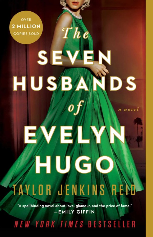 a woman in a green dress is behind the text: the seven husbands of Evelyn Hugo