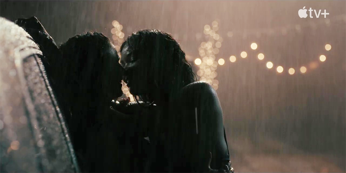Gabrielle Union kisses another woman in the dark in the rain in the trailer for Apple TV+'s new series, Truth Be Told.