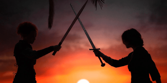 Kit and Jade sword fight in the sunset.