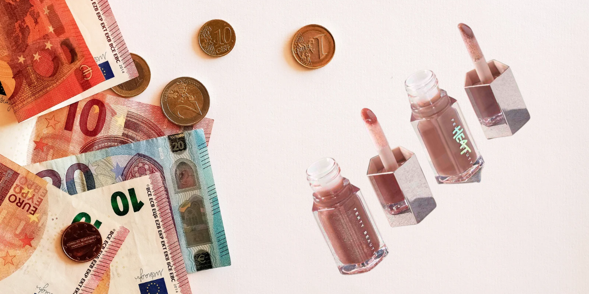 Euro bills and coins & Fenty lip Gloss on a pale pink background