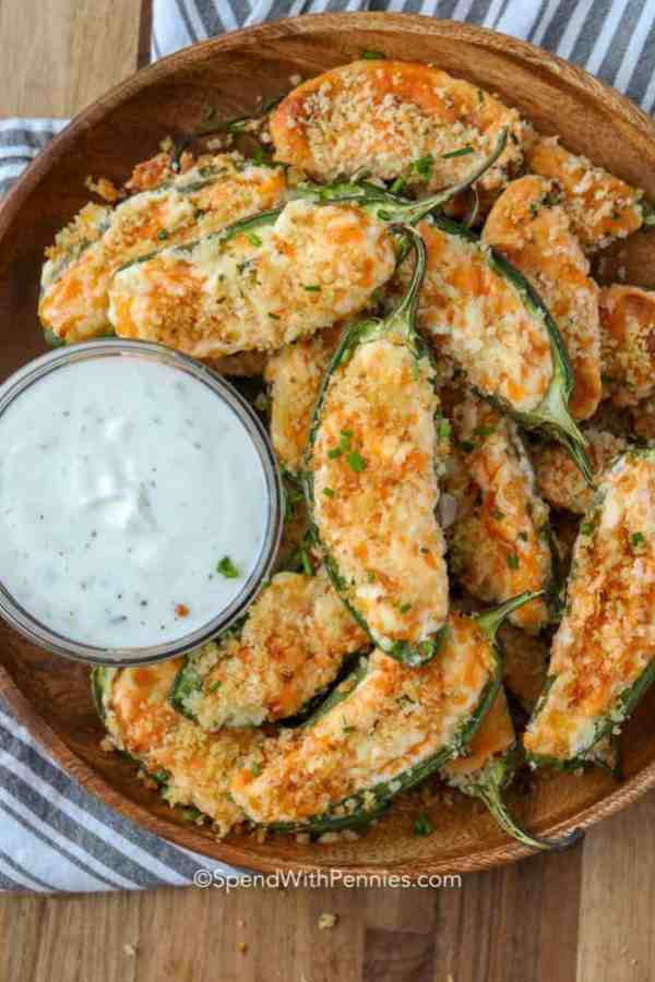 a plate of jalapeño poppers with a side of ranch