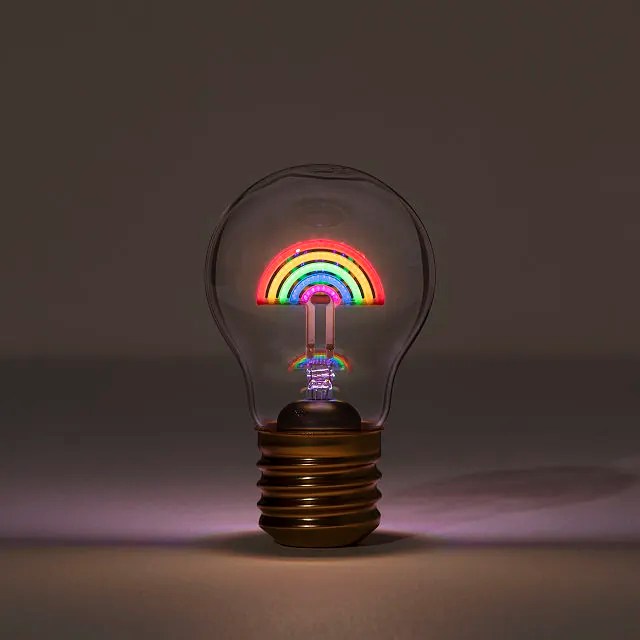 a lightbulb with a glowing rainbow inside it