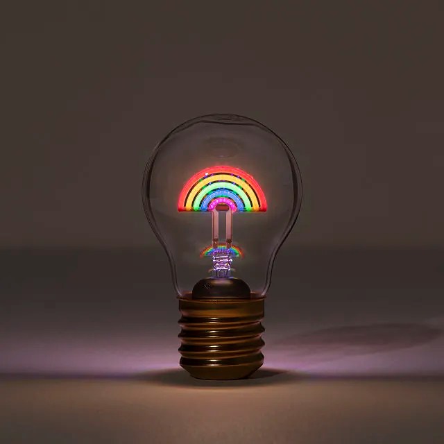 a lightbulb with a glowing rainbow inside it