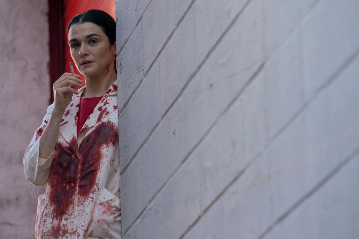 Rachel Weisz holds a cigarette and is covered in blood