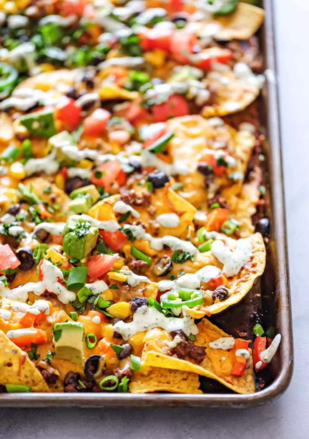 A pan full of nachos and toppings