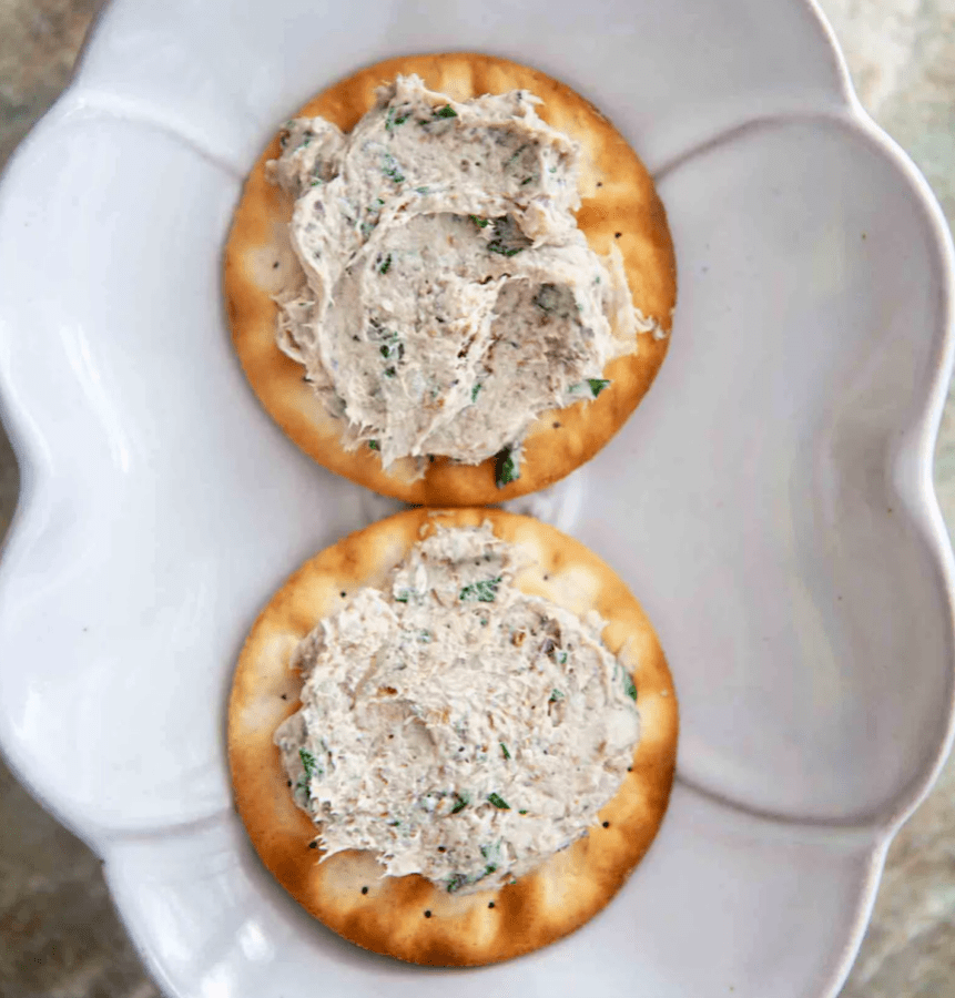 a cracker with sardine rillettes spread on it