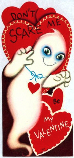 a ghost with severe blue shadows around its eyes holds up its ghostly hands in a threatening manner. text reads on background hearts "don't scare me. be my valentine"
