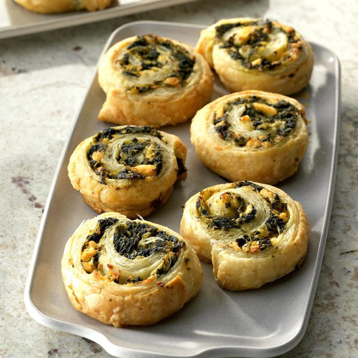 circular pastries with spinach in them