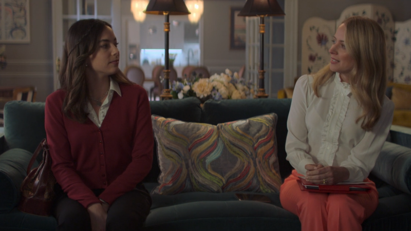 The Watchful Eye: Amy Acker's Tory sits on a couch with and shoots a side-eye at Elena.