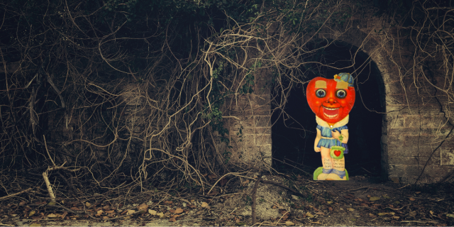 there is a creepy stone tunnel in the dark, barren woods. from it emerges a cut-out figure from a vintage valentine's day card. instead of a head there is a heart with a disturbingly realistic mouth as well as giant soul-piercing eyes. the rest of the figure is some kind of cutesy white girl in a blue dress holding a purse with a heart on it. the heart head also has a hat.