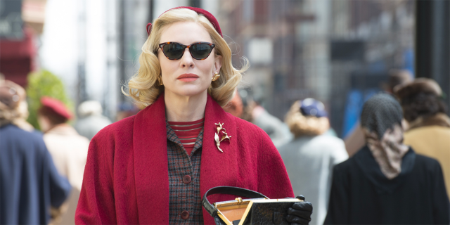 Cate Blanchett as Carol Aird in a red coat and sunglasses.