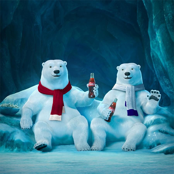 The Coca-Cola bears enjoying a soda in their ice den