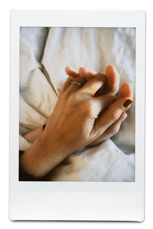 Kristen and Kayla's hands. Kayla has an engagement ring on