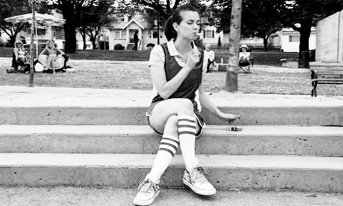 a gif of Jenny from The L Word smoking on a basketball court