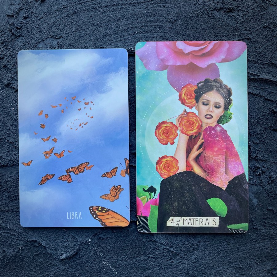 Two cards in front of a navy blue background, right to left: Libra (a family of butterflies flying in a blue sky) and 4 of Materials (a woman with her hair braided around the crown of her head holding a variety of roses)