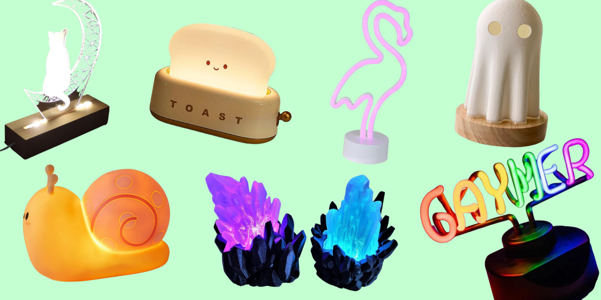 a lamp shaped like a cat sitting on a crescent moon, a light-up snail figurine, a light-up toaster with a smiling toast coming out of it, two light-up crystal lamps in purple and blue, a flamingo LED light, a sheet ghost lamp, and a neon sign that says GAYMER in rainbow letters