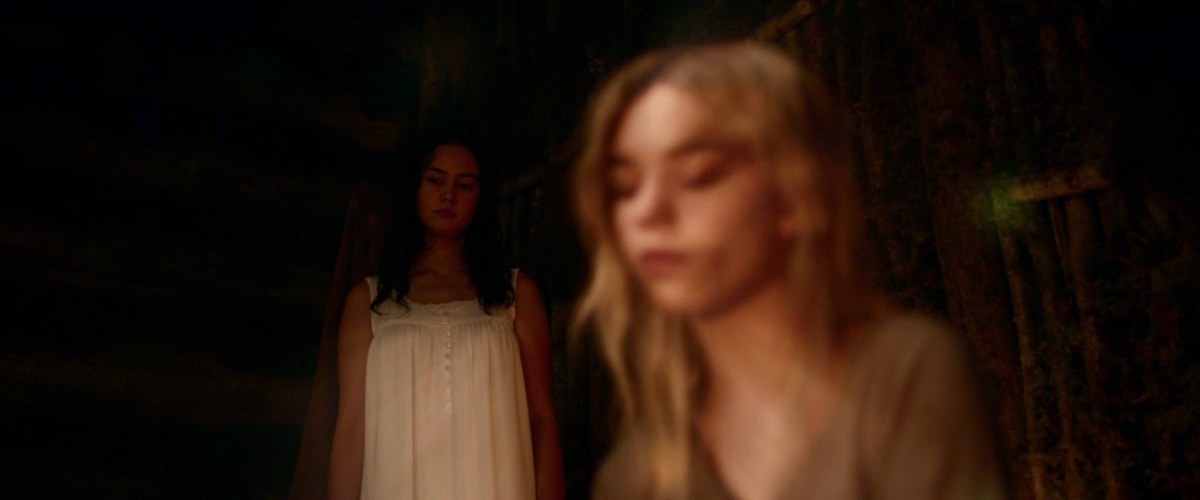 Teen Lottie stands behind Teen Nat in Yeellowjackets