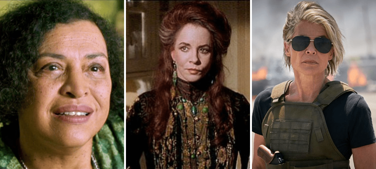 aunt frances: Aunt Frances (Stockard Channing) has long brown hair in a half-updo and is wearing lots of jewelry and a high-neck long-sleeved dress, all in a dark motif. She’s standing indoors next to Aunt Jet (Dianne Wiest) who has a similar hairstyle and is wearing similar clothing and jewelry but in a light motif. The scene is tense. linda hamilton: A muscular woman over 50 stands confidently on an overpass wearing a dark fitted t-shirt under an army green combat vest, and dark aviator sunglasses. Her chin-length hair is blonde-grey and straight with a side part. Behind her is a fiery pileup of vehicles. the oracle: A friendly-looking woman with dark jaw-length hair is wearing a green floral blouse and dark green apron. She sits in a friendly green-yellow kitchen, looking very approachable and warm.