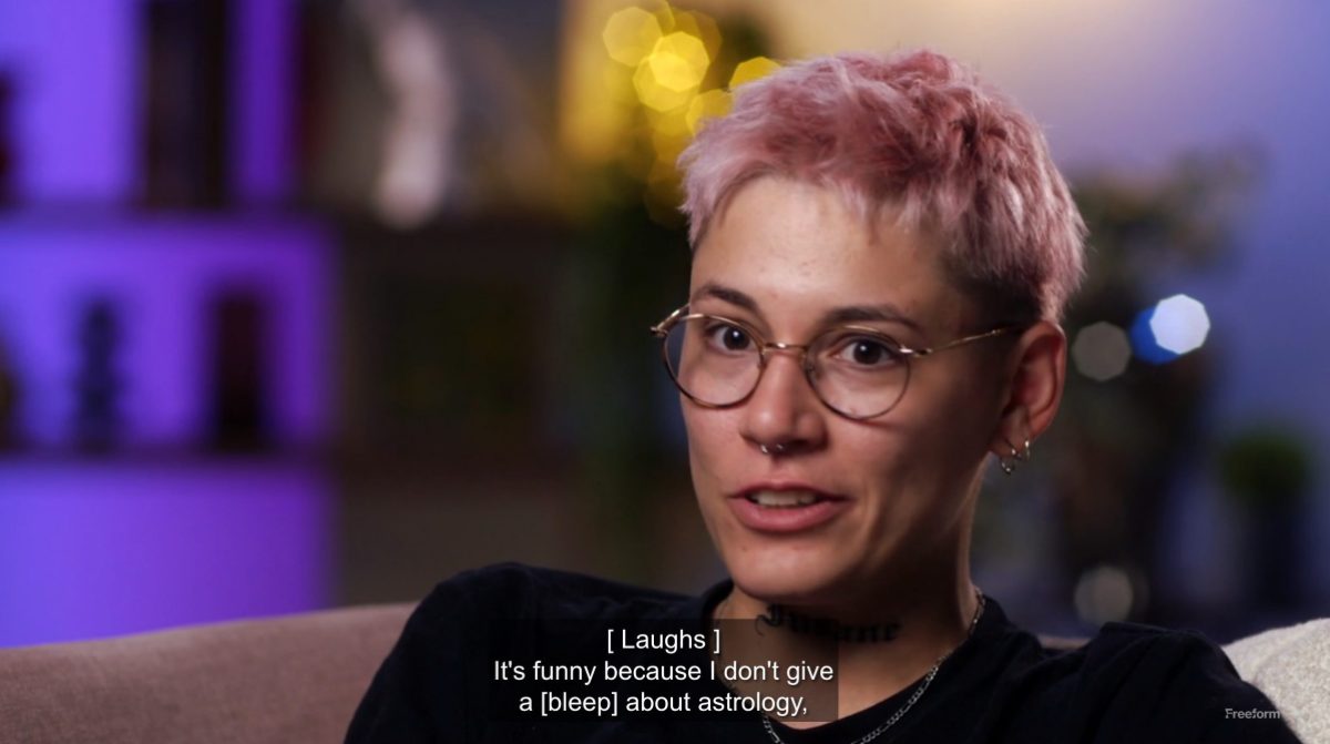 Pink haired lesbian saying, "It's funny because I don't give a [bleep] about astrology"