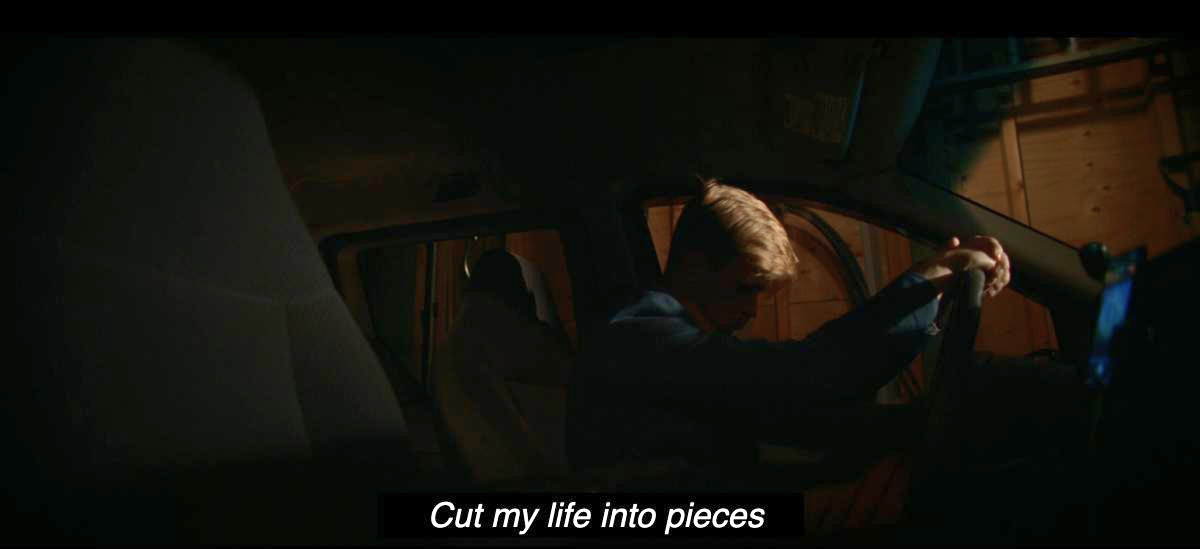Jeff in a car with closed captions that read "Cut my life into pieces"