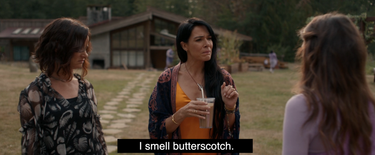 Adult Lottie says "I smell butterscotch" standing next to Nat and Lisa in Yellowjackets 202