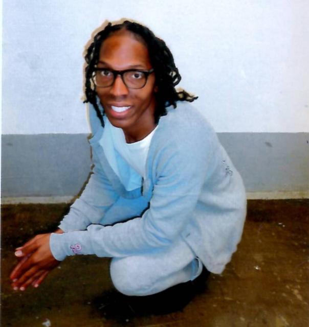 Photo of Tavaria Merritt. She is Black with shoulder length hair wearing blue jeans and a blue top.