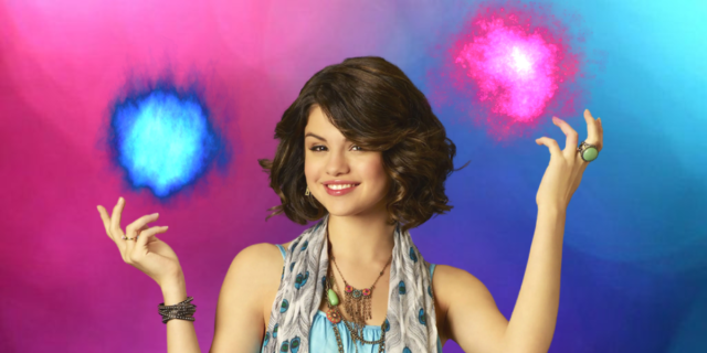 Selena Gomez as Alex Russo in Wizards of Waverly Place, photoshopped in front of the bi pride colors with pink and blue fire balls above her hands.