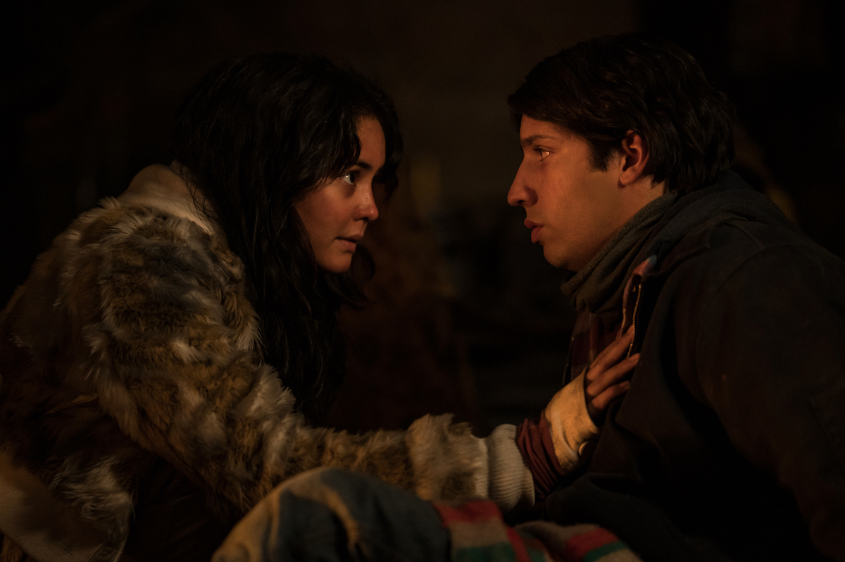 (L-R): Courtney Eaton as Teen Lottie and Kevin Alves as Teen Travis in YELLOWJACKETS Season 2 are crouched in the cabin. Photo Credit: Kailey Schwerman/SHOWTIME.