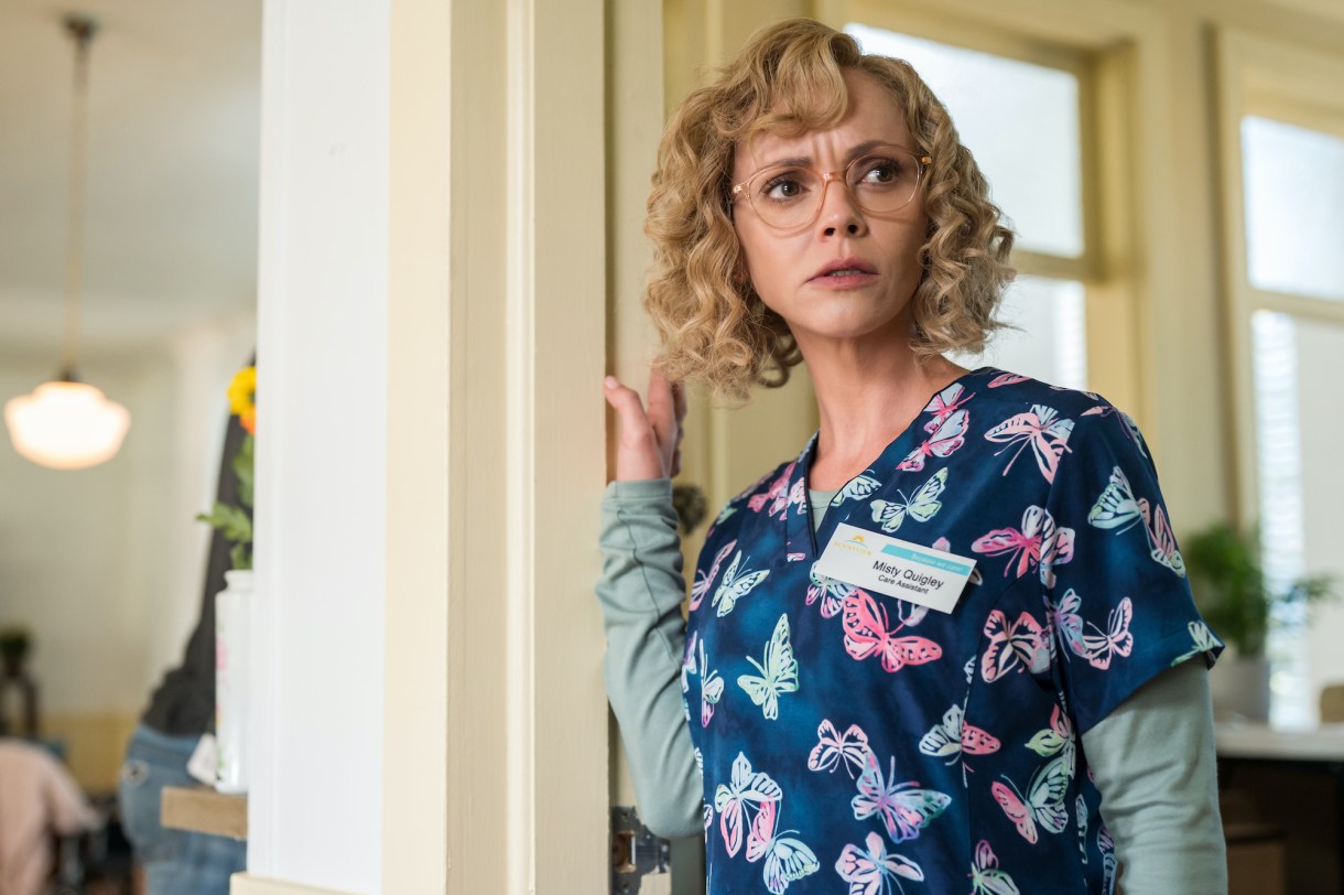 Christina Ricci as Misty in YELLOWJACKETS Season 2 wears butterfly scrubs and looks concerned. Photo Credit: Kailey Schwerman/SHOWTIME.