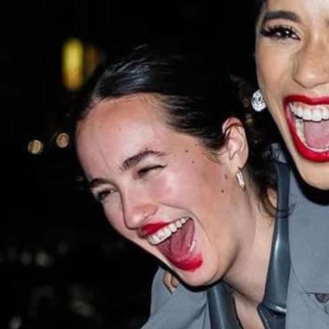 A close up of Jasmin Savoy Brown and her partner, Anouk, Anouk's face is smeared with Jasmin's red lipstick.