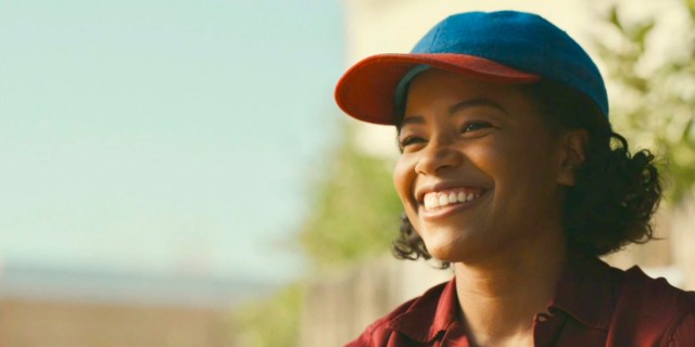 Max Chapman smiles while wearing her baseball hat in A League of Their Own