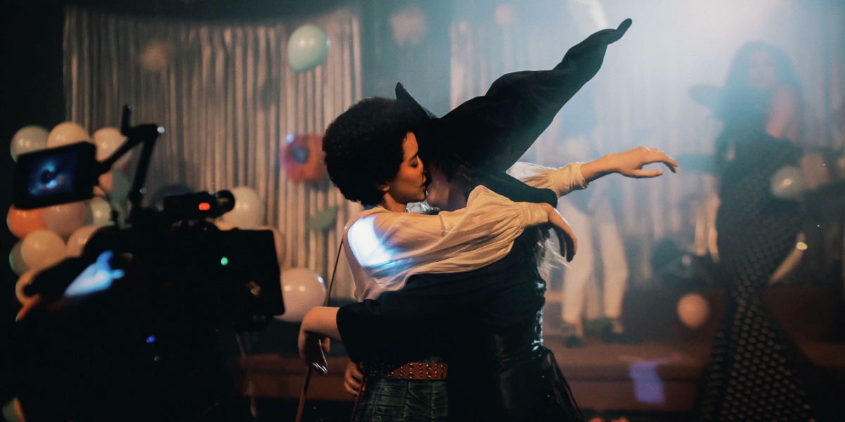Jasmin Savoy Brown kisses Lucy Dacus who is wearing a witch costume in the "Night Shift" music video.