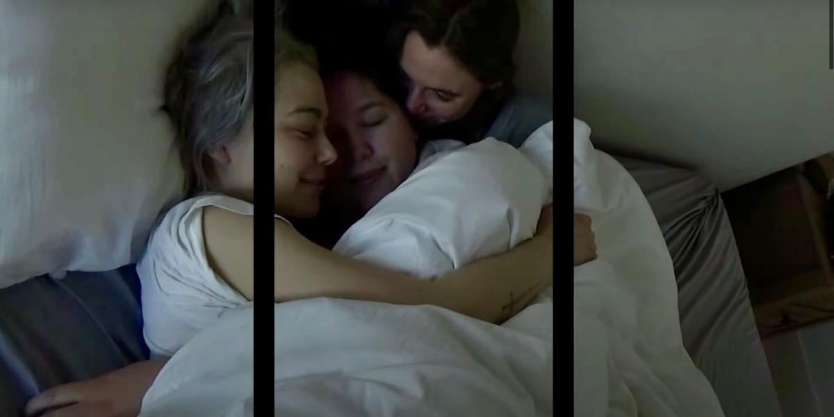 The members of Boygenius Phoebe Bridgers, Lucy Dacus, and Julien Baker in a bed together, snuggling