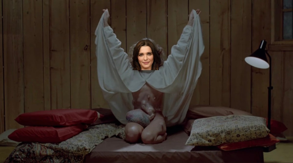 A still from The Brood of Samantha Eggar lifting her white robe up to reveal babies growing from her abdomen with Rachel Weisz's head photoshopped on her body.