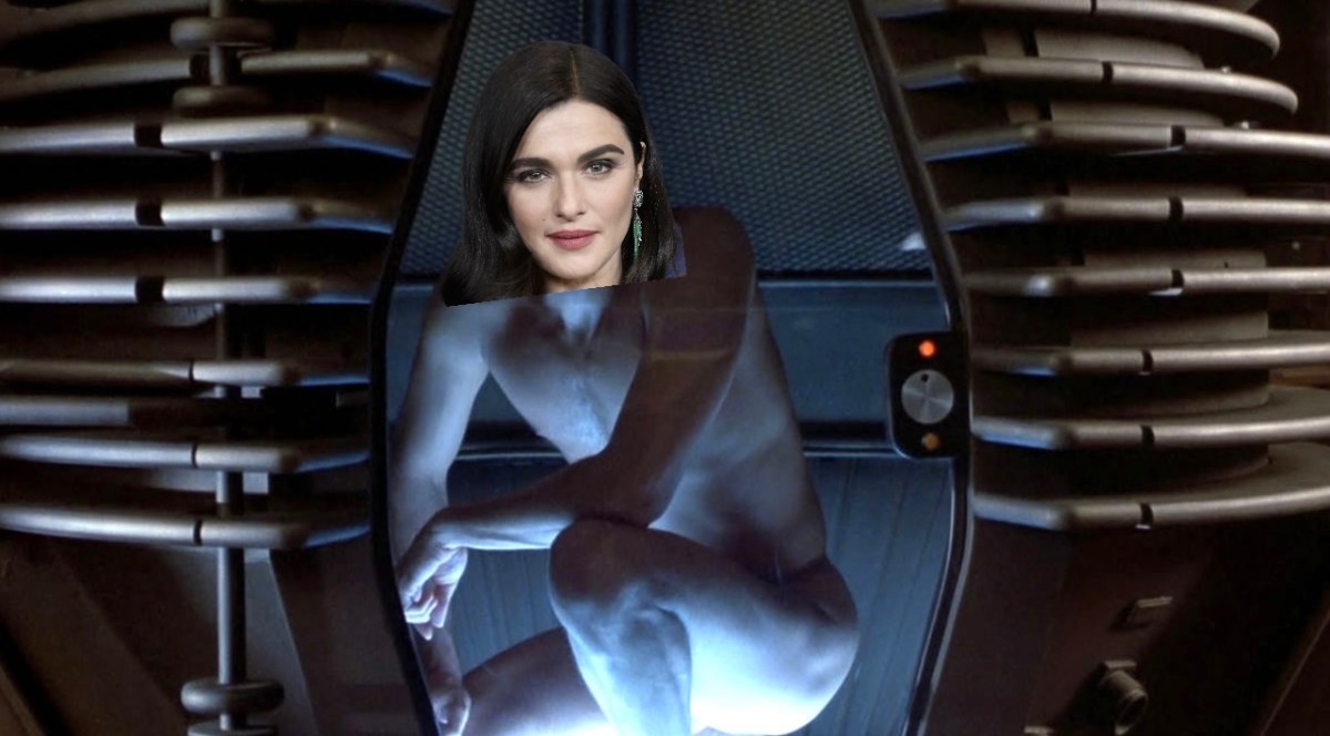 A still of Jeff Goldblum in The Fly naked in the teleportation pod with Rachel Weisz's head poorly photoshopped on his body.