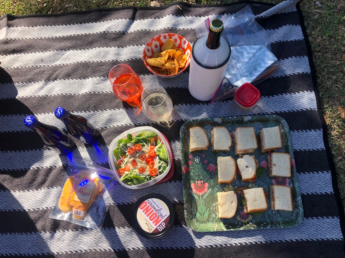 tiny sandwiches, salad, seltzer, wine, corn chips, caramelized onion dip, sliced mango