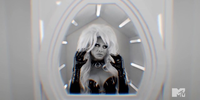 Drag Race 1514 recap: A black and white image of Sasha Colby dressed as Barb Wire in a spaceship window.