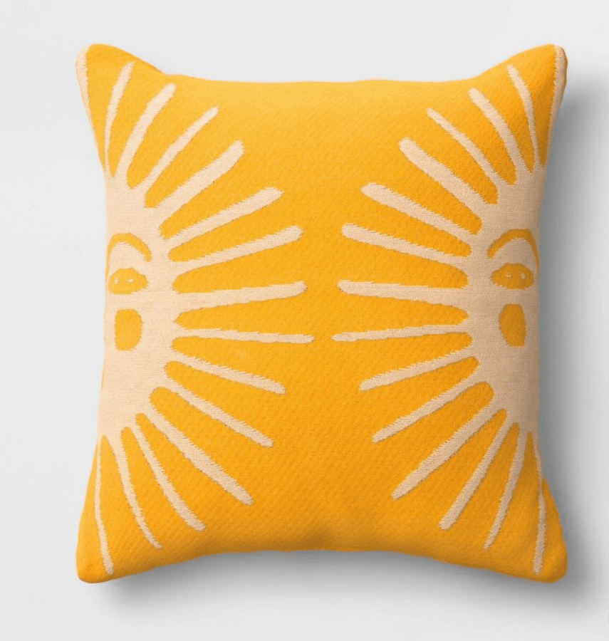a yellow pillow with suns on it