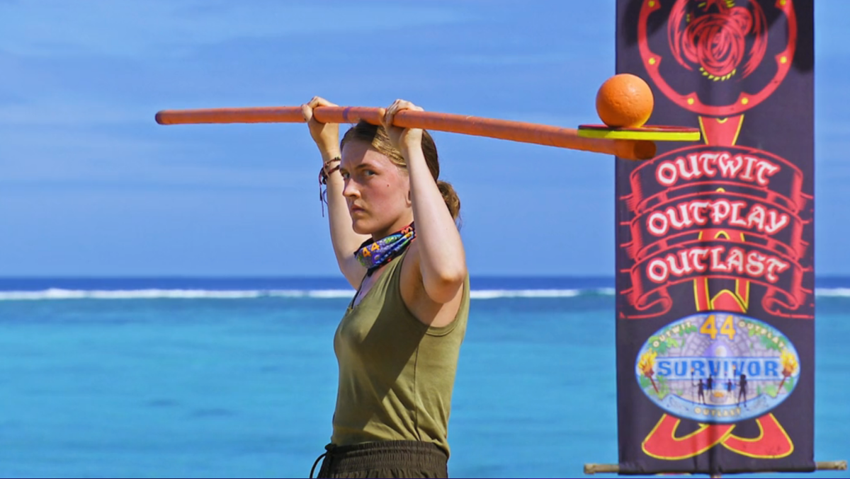 Survivor Season 44 contestant Frannie Marin holds a large beam on her head, on top of which balances a ball, in a challenge on Survivor