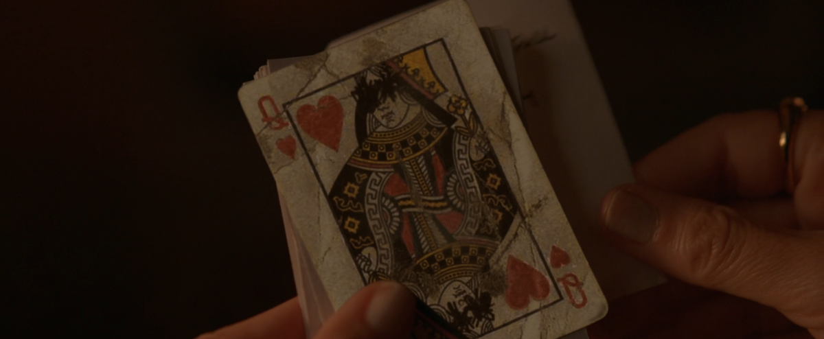 a Queen card with the eyes scratched out