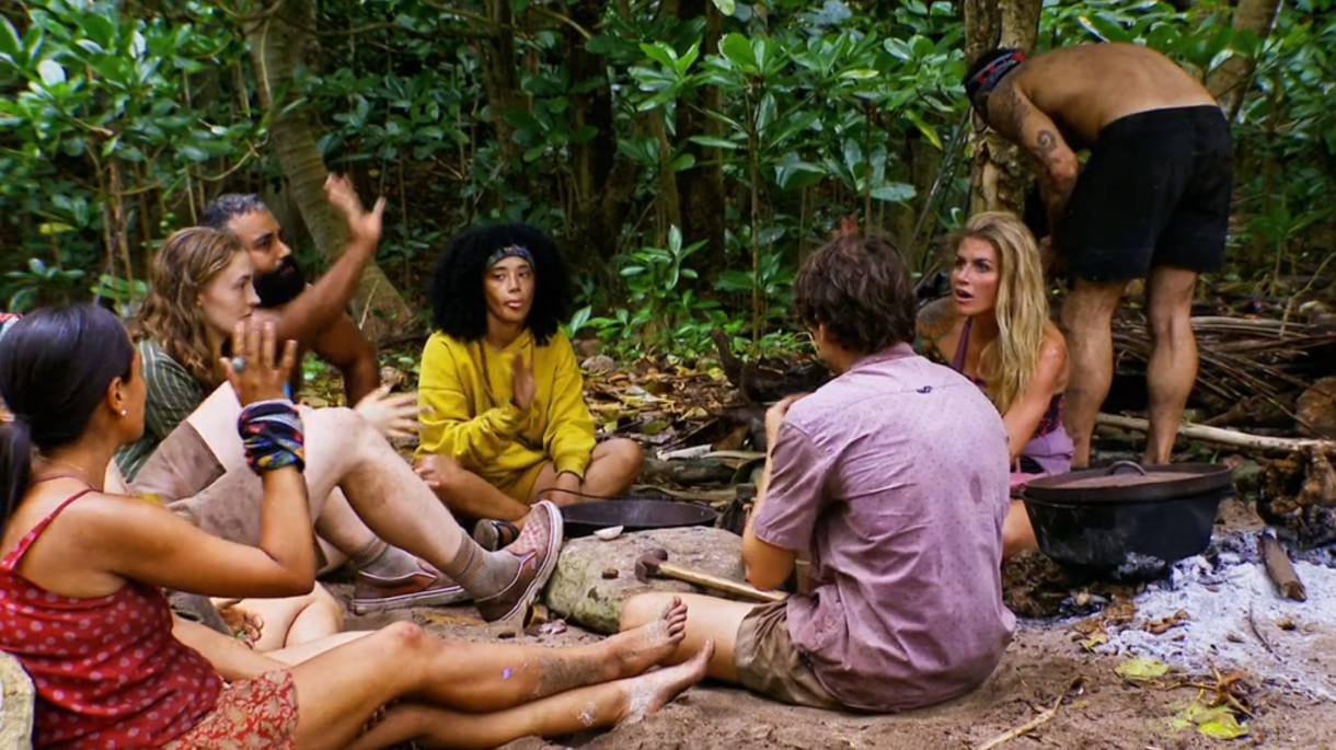 The contestants of Survivor season 44 sit around at camp