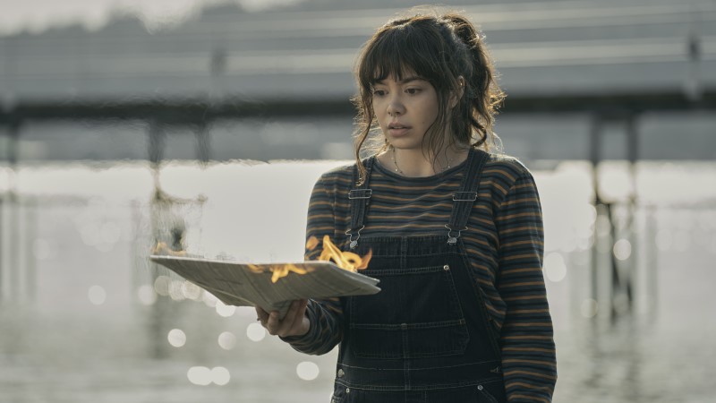 The Power: Auli'i Cravalho as Jos holding a paper she just set on fire with her powers