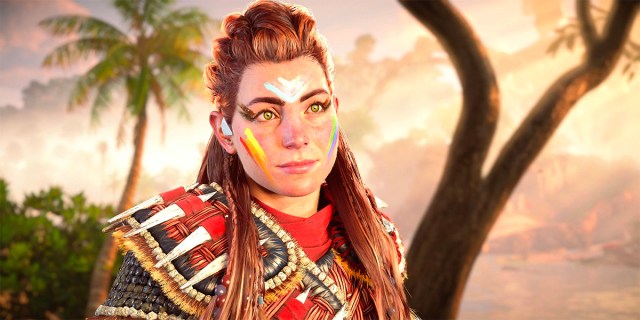 Aloy in Pride face paint and Quen armor in Horizon Forbidden West: Burning Shores