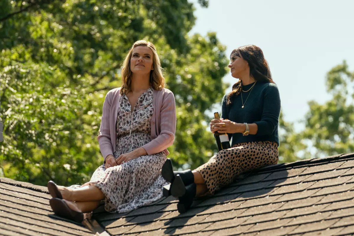 Two middle-aged women on a roof