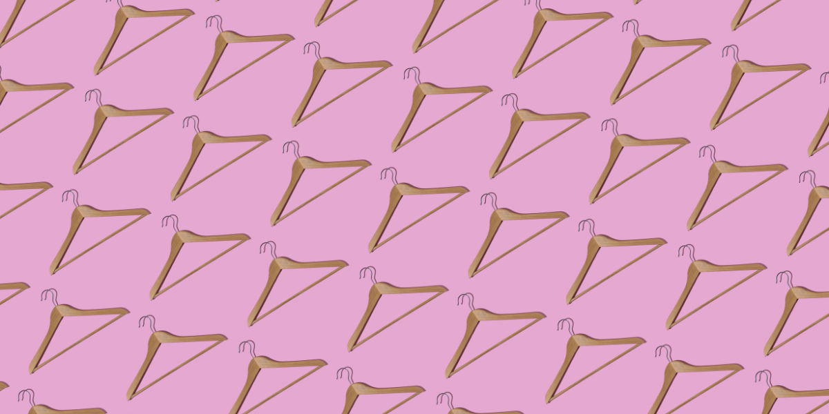 a bunch of hangers against a pink background