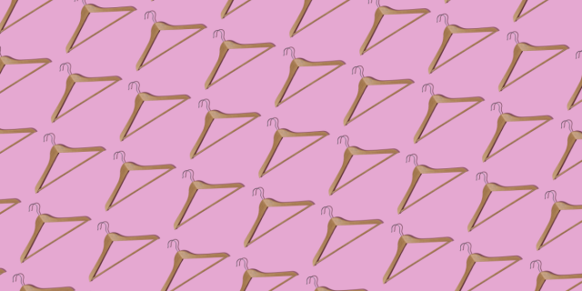 a bunch of hangers against a pink background