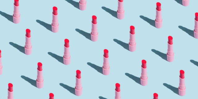 a bunch of lipstick lined up on a blue background